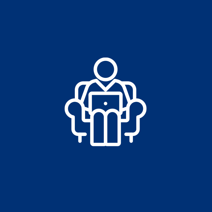 White icon of a person using a laptop on an armchair on a blue background, representing efficiency