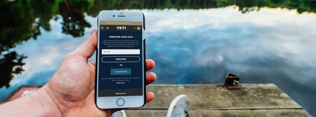 Image showing a hand holding a phone with person shopping on YETI website
