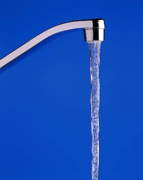 Image showing water flowing from a tap against a blue background.