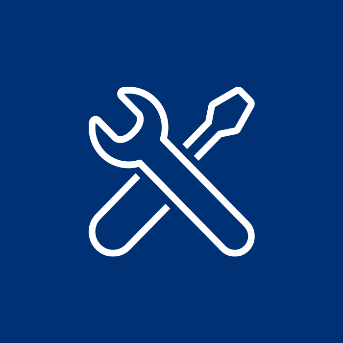Icon of a crossed wrench and screwdriver on a blue background, symbolizing tools